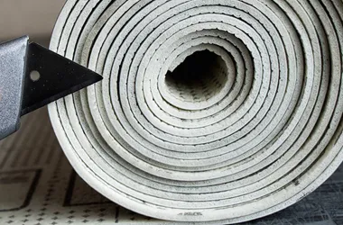 Twisted linoleum. Sliced and rolled linoleum is stacked on a table.