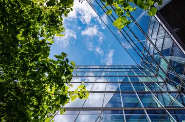 View upwards of a modern facade of an office building and trees