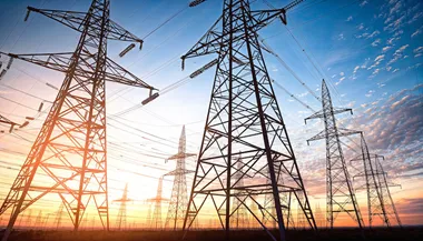 High-voltage power lines at sunset. electricity distribution station.