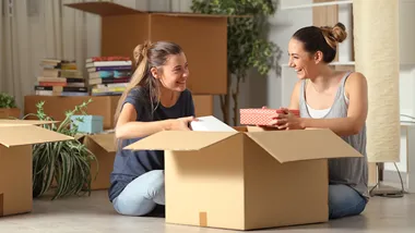 Roommates talking unboxing gelongings moving home